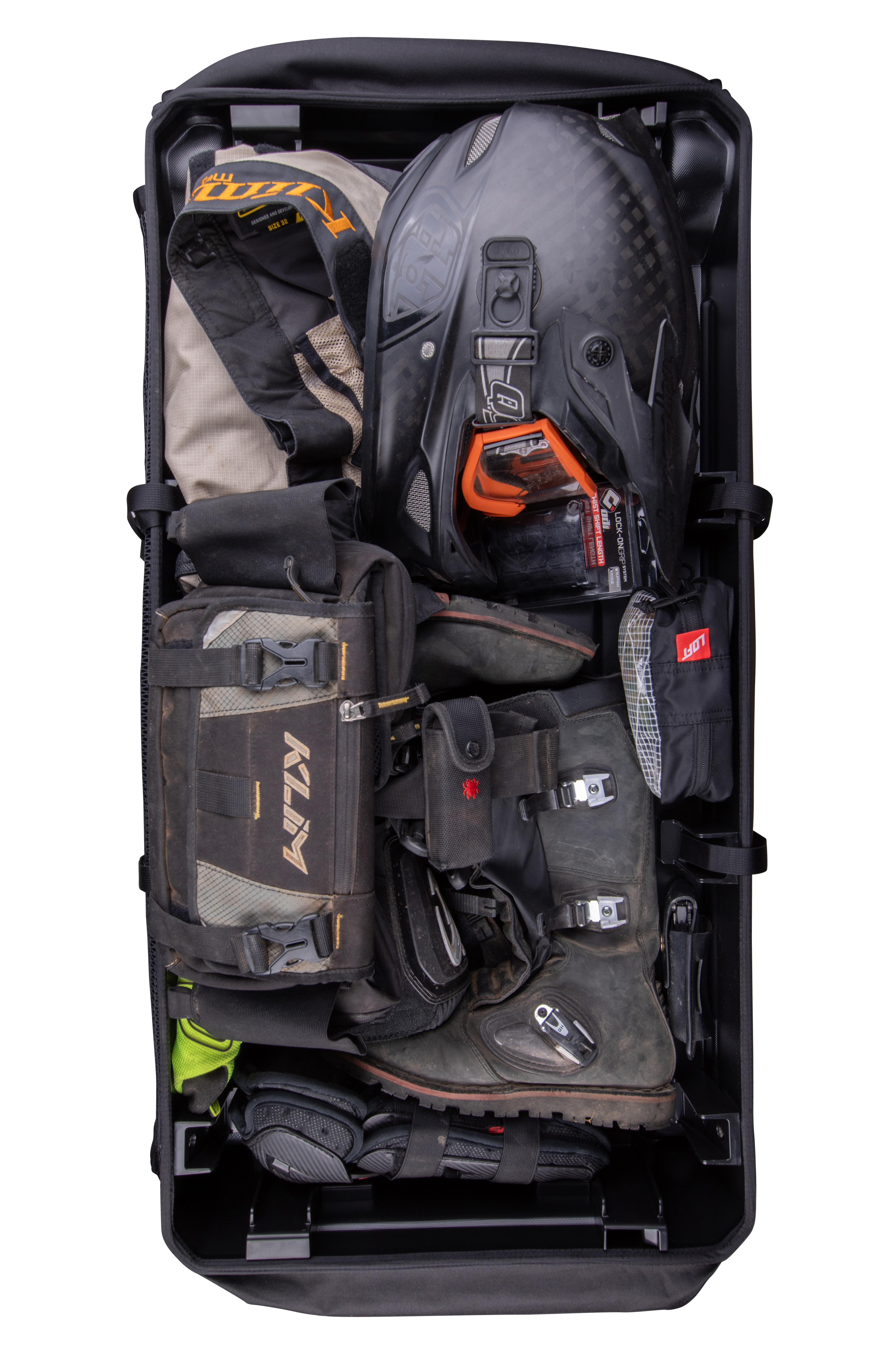 Two duffle bags in the foreground of a camping setting with seated people in the background.